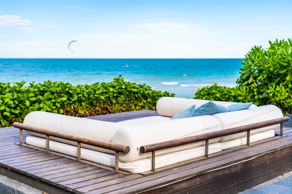 Beautiful outdoor nature landscape with pillow on sofa and lounge around tropical beach sea and ocean in hua hin Thailand