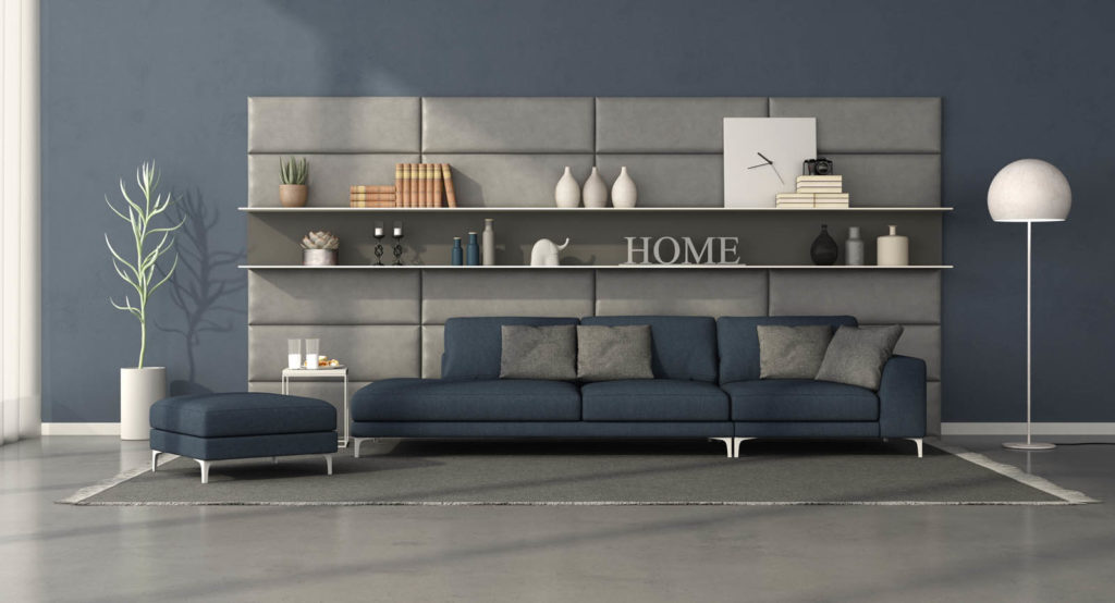 Modern living room with dark blue sofa in front of a leather panel with shelves - 3d rendering